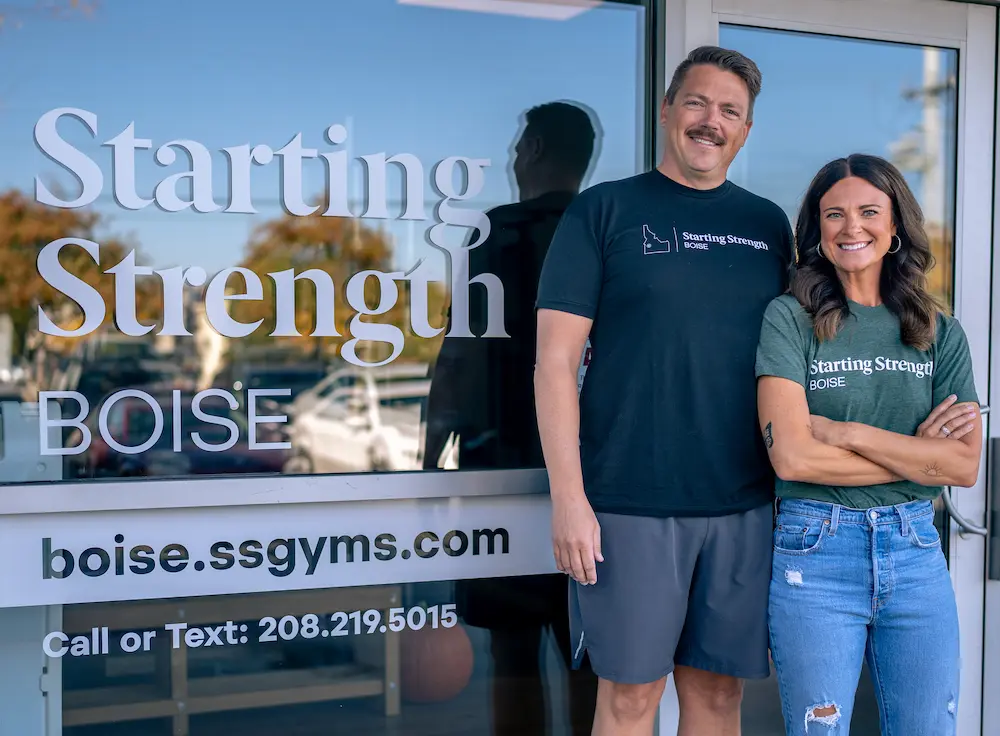 Front of a Starting Strength Gym with two Owners posing