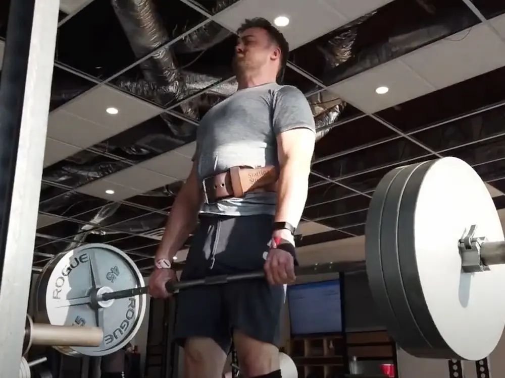 Male athlete in Starting Strength shirt performing heavy deadlift